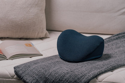 Lifestyle image of HALO Neck Stretch Pillow placed on sofa.