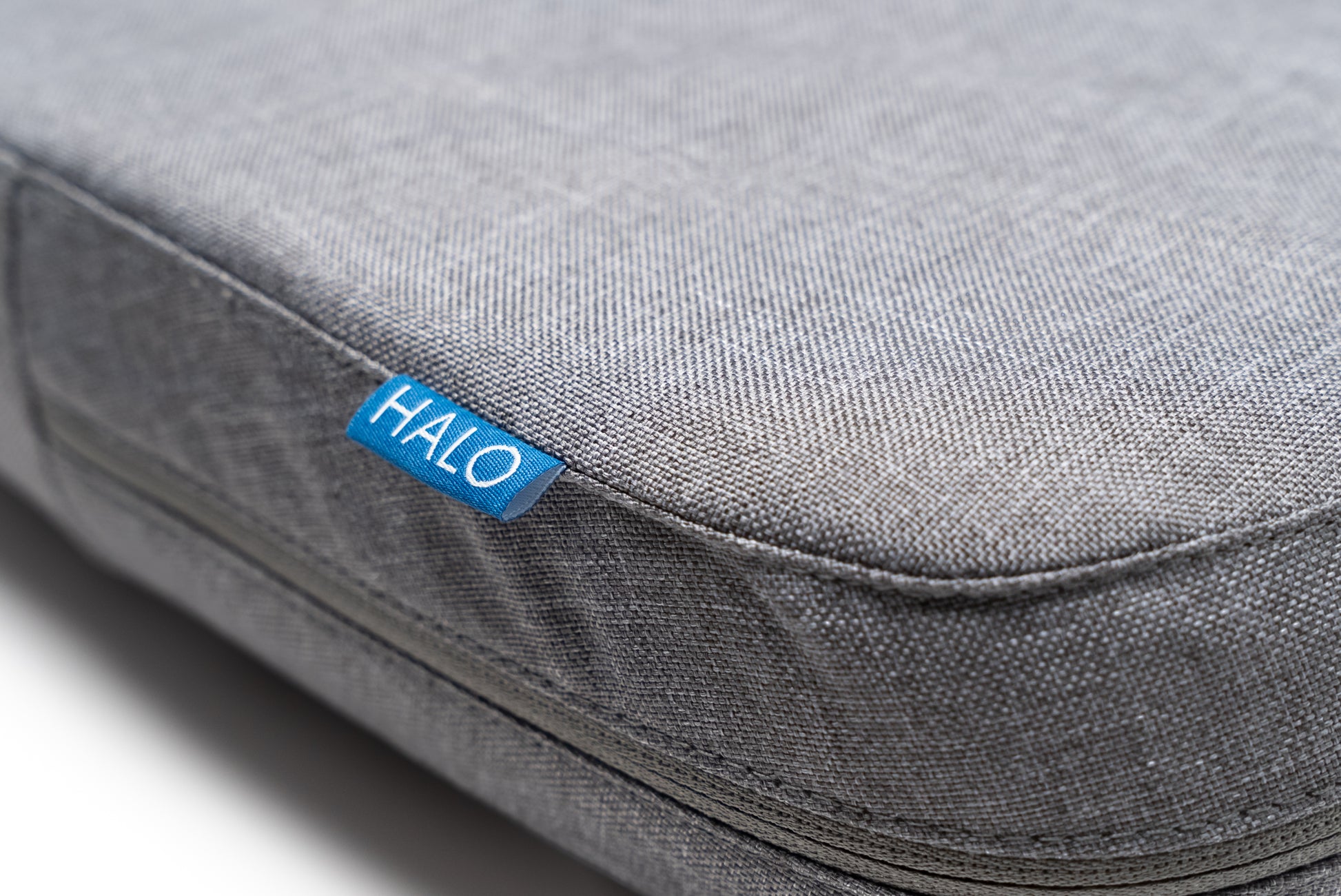 Close up image of the HALO Back Stretch Massage Cushion to show the HALO logo and materials and fabric quality.
